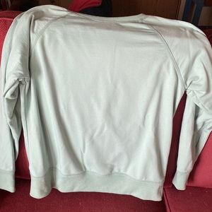Mint green Amazon sweatshirt.